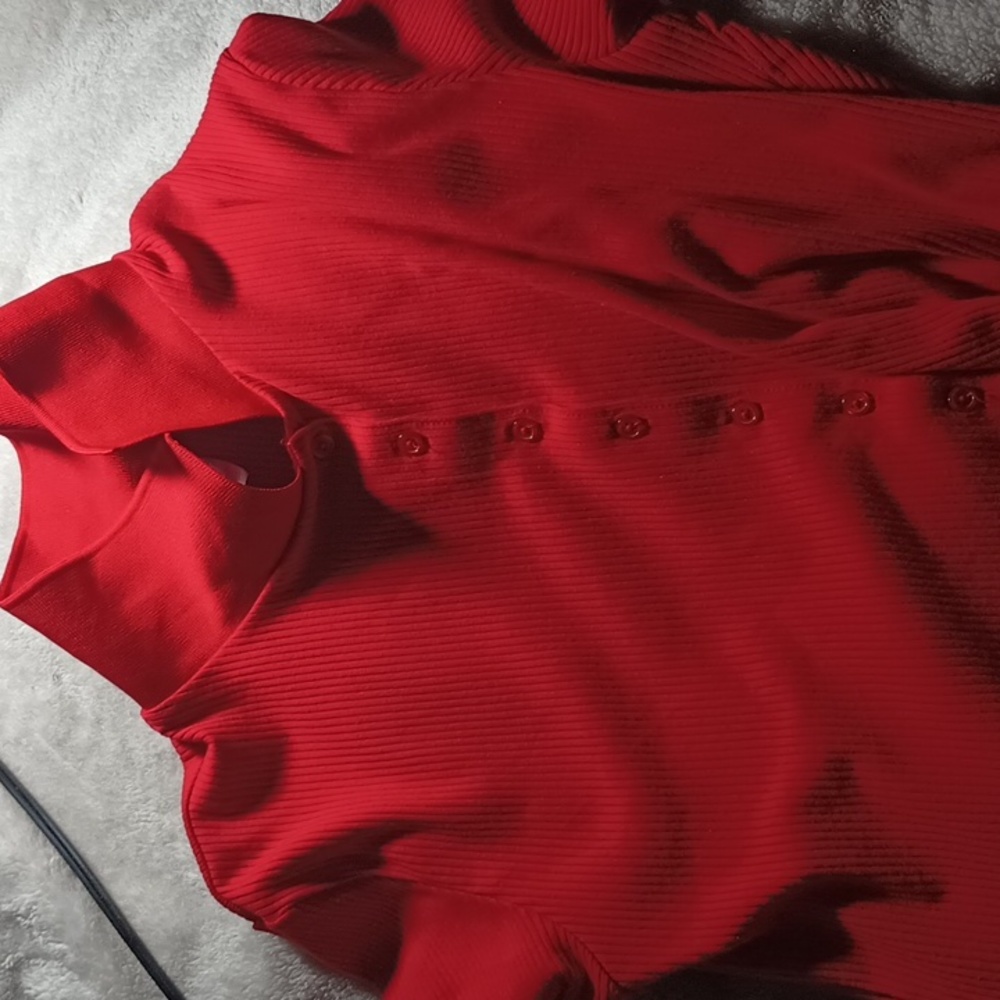A red button up cop turtle neck